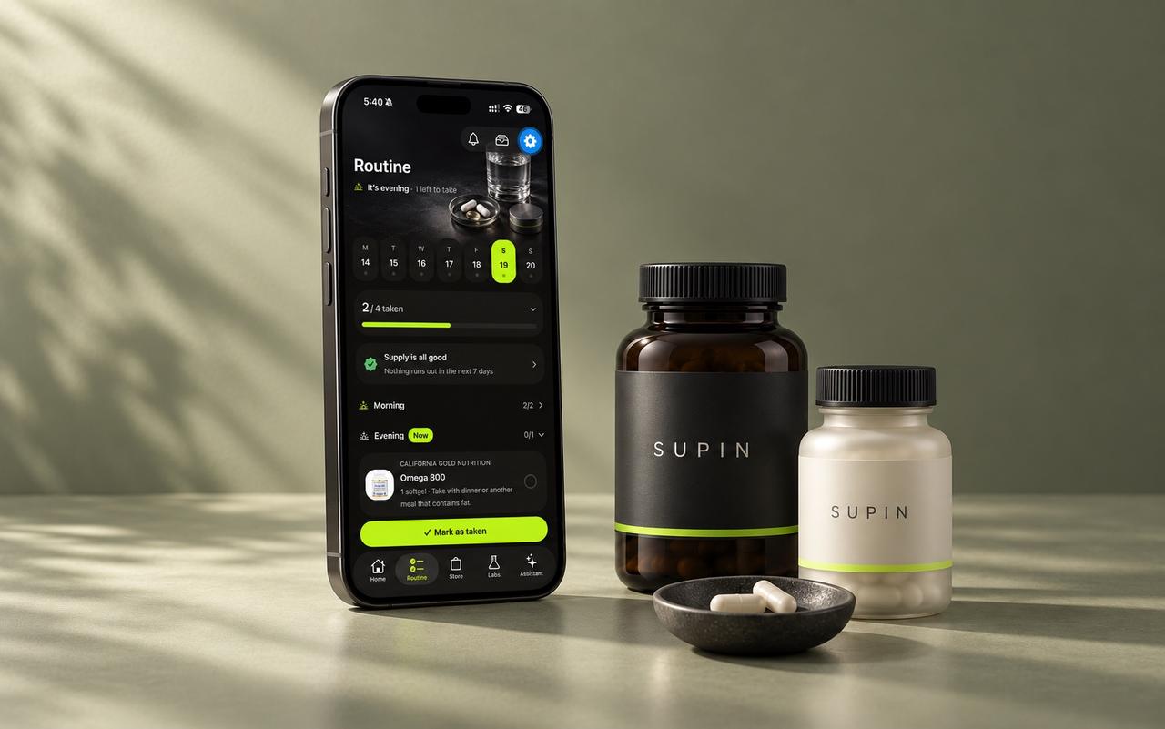 An iPhone displaying Supin's Routine screen beside SUPIN bottles with charcoal and ivory labels.